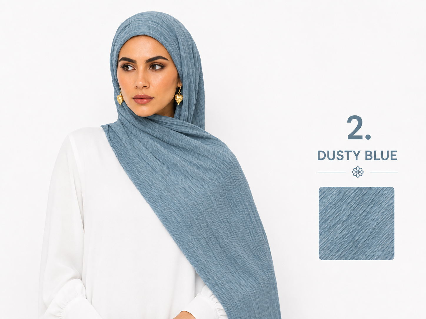 A woman wearing a dusty blue hijab draped over her shoulders, paired with a white top. The image includes a text overlay reading '2.
